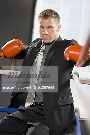 Portrait of a young man sitting in a boxing ring