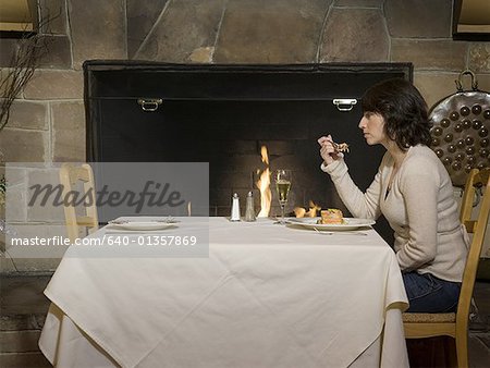 Profile of a mid adult woman eating food