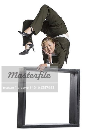 Female contortionist businesswoman outside the box