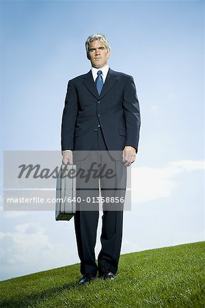 Low angle view of a businessman holding a briefcase