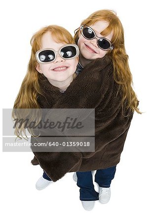 High angle view of two girls wrapped in a blanket