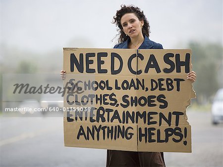 A young woman holding a help- needed sign