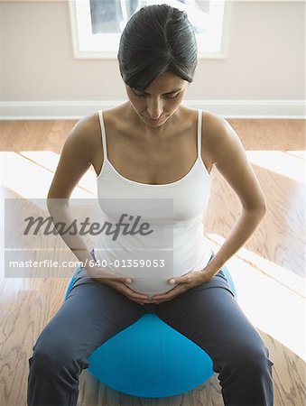 High angle view of a pregnant woman sitting on a fitness ball