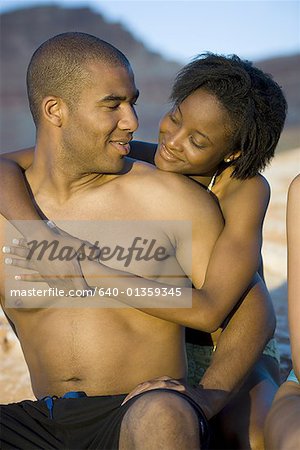 Young couple hugging outdoors