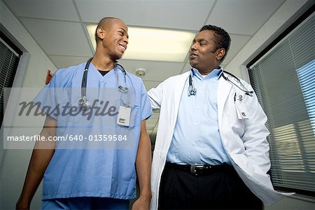 Low angle view of two male doctors walking in a corridor