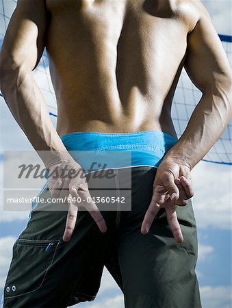 Volleyball player standing by net