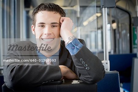 Portrait of a young man sitting in a commuter train