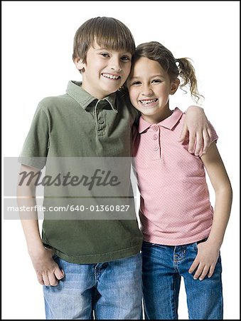 Portrait of a boy standing with his arm around his sister