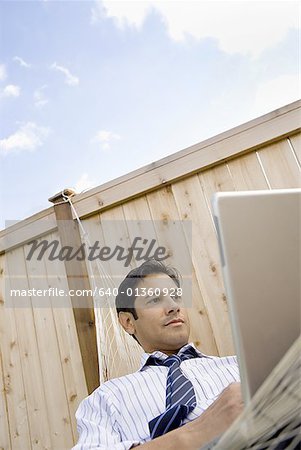 Low angle view of a businessman using a laptop