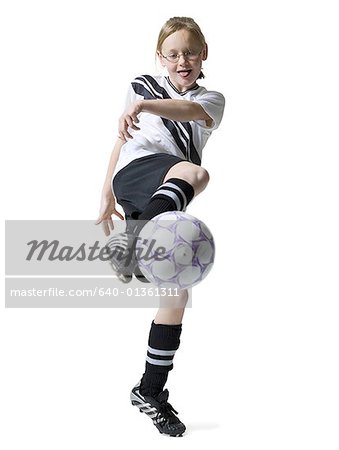 Girl kicking a soccer ball