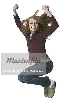 Portrait of a girl jumping with her arms raised