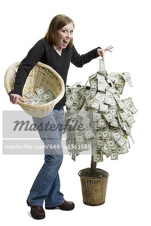 Portrait of a young woman standing near a money tree