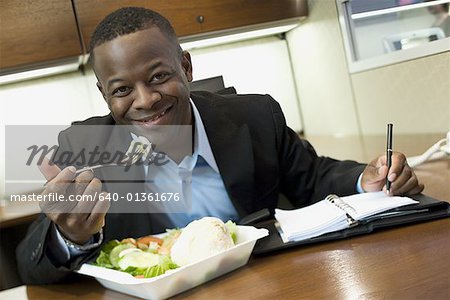 Portrait of a man eating in the office