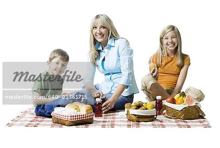 Portrait of a mother and her two children having a picnic