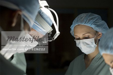 Four surgeons operating