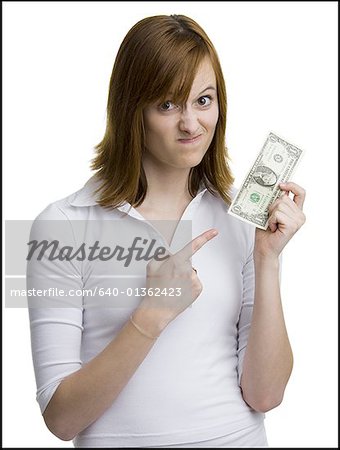 Portrait of a young woman holding an American one dollar bill