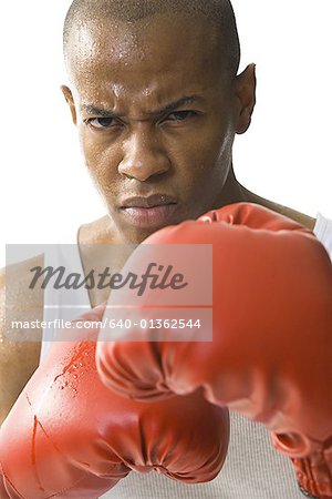 Close-up of a young man wearing boxing gloves