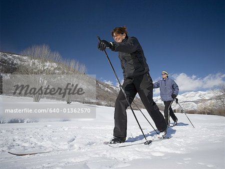 Man and woman cross country skiing