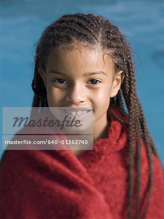 Portrait of a girl wrapped in a towel and smiling