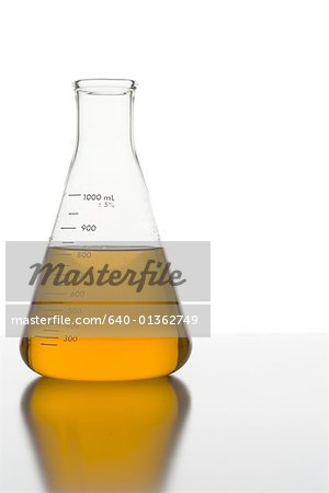 Close-up of a conical flask with orange liquid