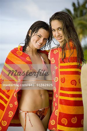 Portrait of two teenage girls wrapped in towels