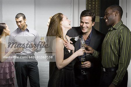 Group of people talking at a party