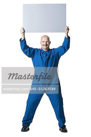 Portrait of a man holding up a blank sign