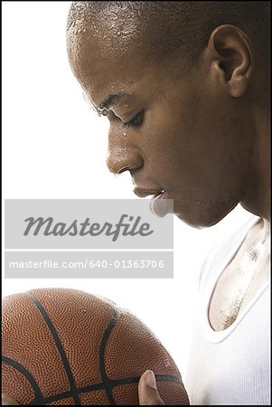 Close-up of a young man preparing to shoot a basketball