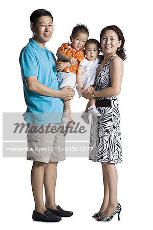 Asian parents with young boy and baby daughter