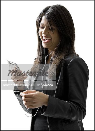 Close-up of a young woman looking at a portable video player