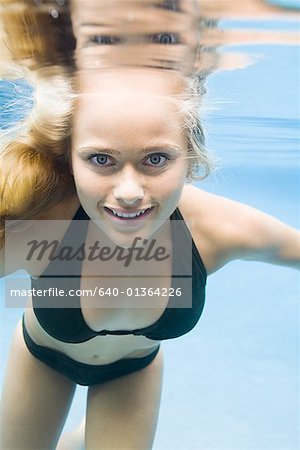 Portrait of a teenage girl swimming underwater