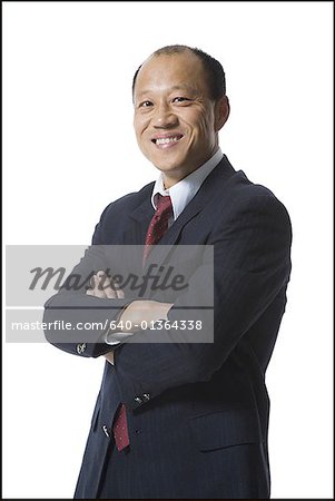 Portrait of a businessman standing with his arms folded and smiling
