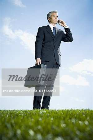 Low angle view of a businessman talking on a mobile phone