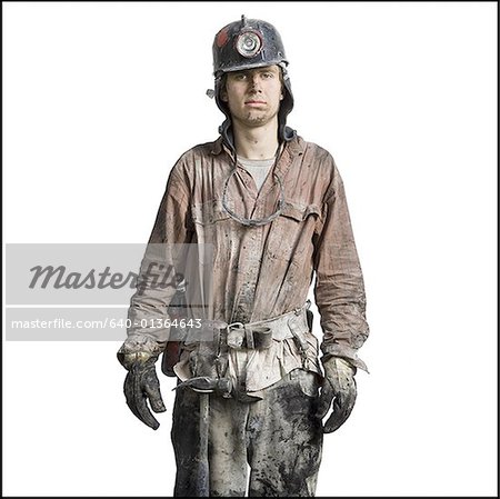 Close-up of a miner wearing a hardhat with a headlamp