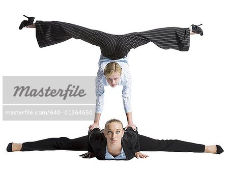 Two female contortionist businesswomen