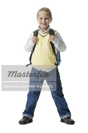 Portrait of a boy smiling and carrying a backpack