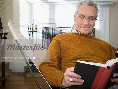 Close-up of an elderly man reading a book