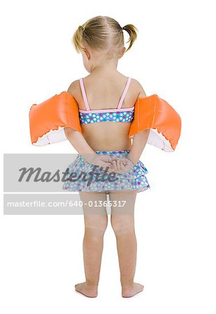 Young girl with personal flotation devices around arms