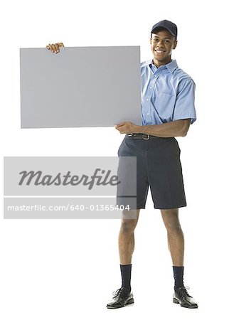 Portrait of a young man holding a blank sign