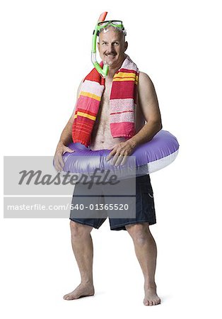 Portrait of a man standing with an inflatable ring around his waist