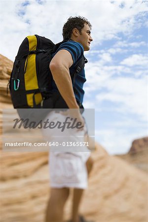 Profile of a young man carrying a backpack