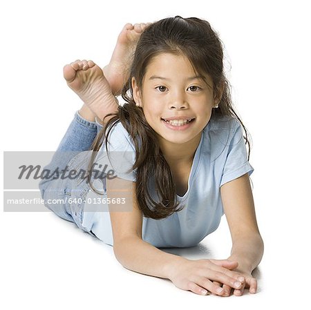 Portrait of a girl lying on the floor and smiling