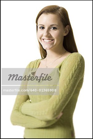 Portrait of a young woman standing with her arms folded
