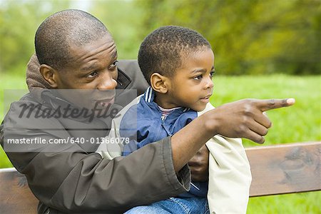 Close-up of a father sitting with his son