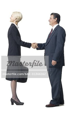 Businesswoman with head backwards shaking hands with businessman