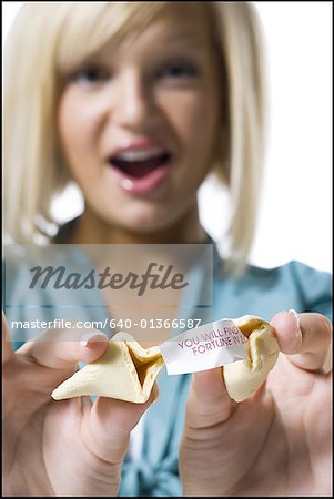 Woman opening fortune cookie