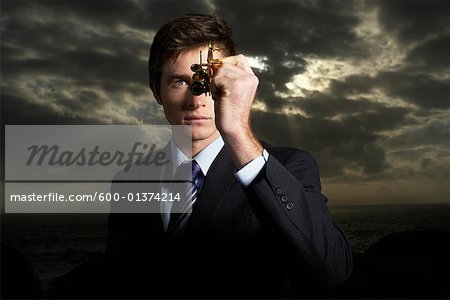 Businessman Looking Through Navigational Instrument