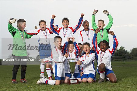 Portrait of Soccer Team With Gold Medals and Trophy