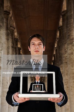 Businessman with Image on Laptop Computer
