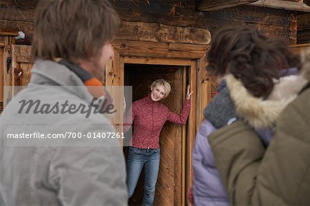 Femme à la porte d'entrée, accueil des visiteurs